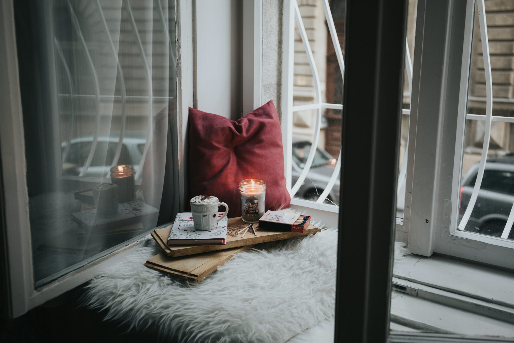 A window seat with cushions and a tray — a corner that works