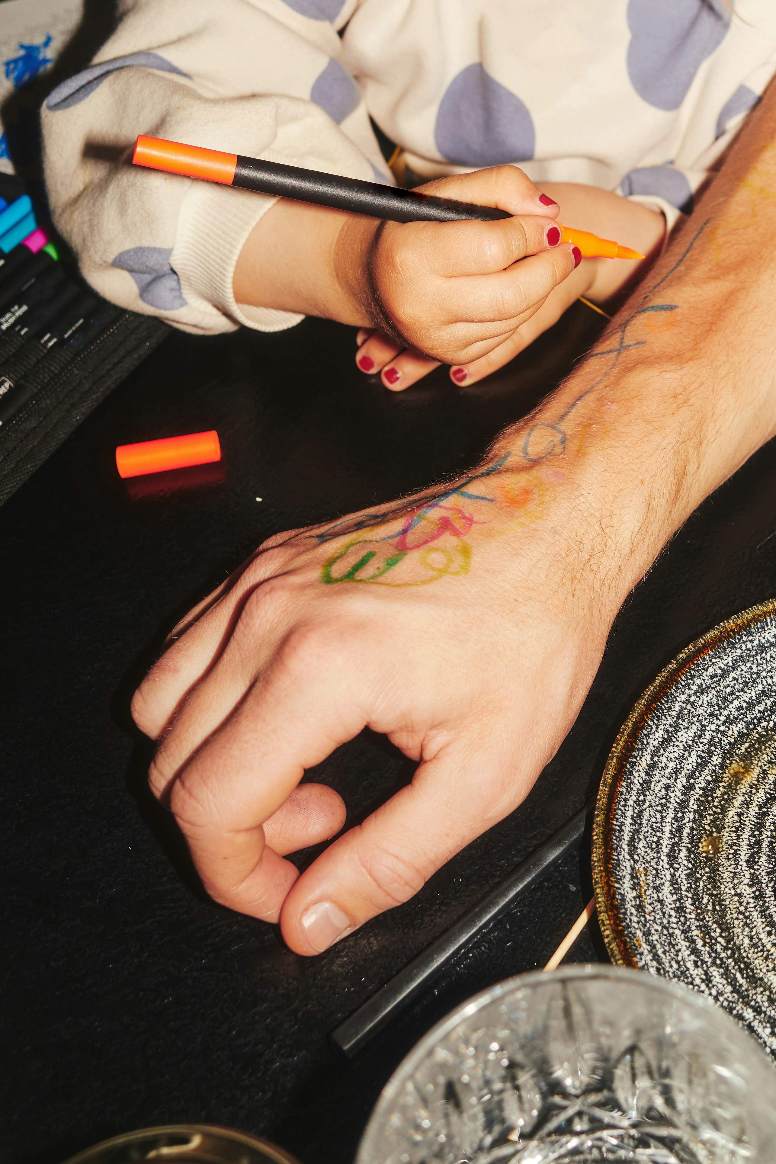 Someone writing on the back of their own hand in marker
