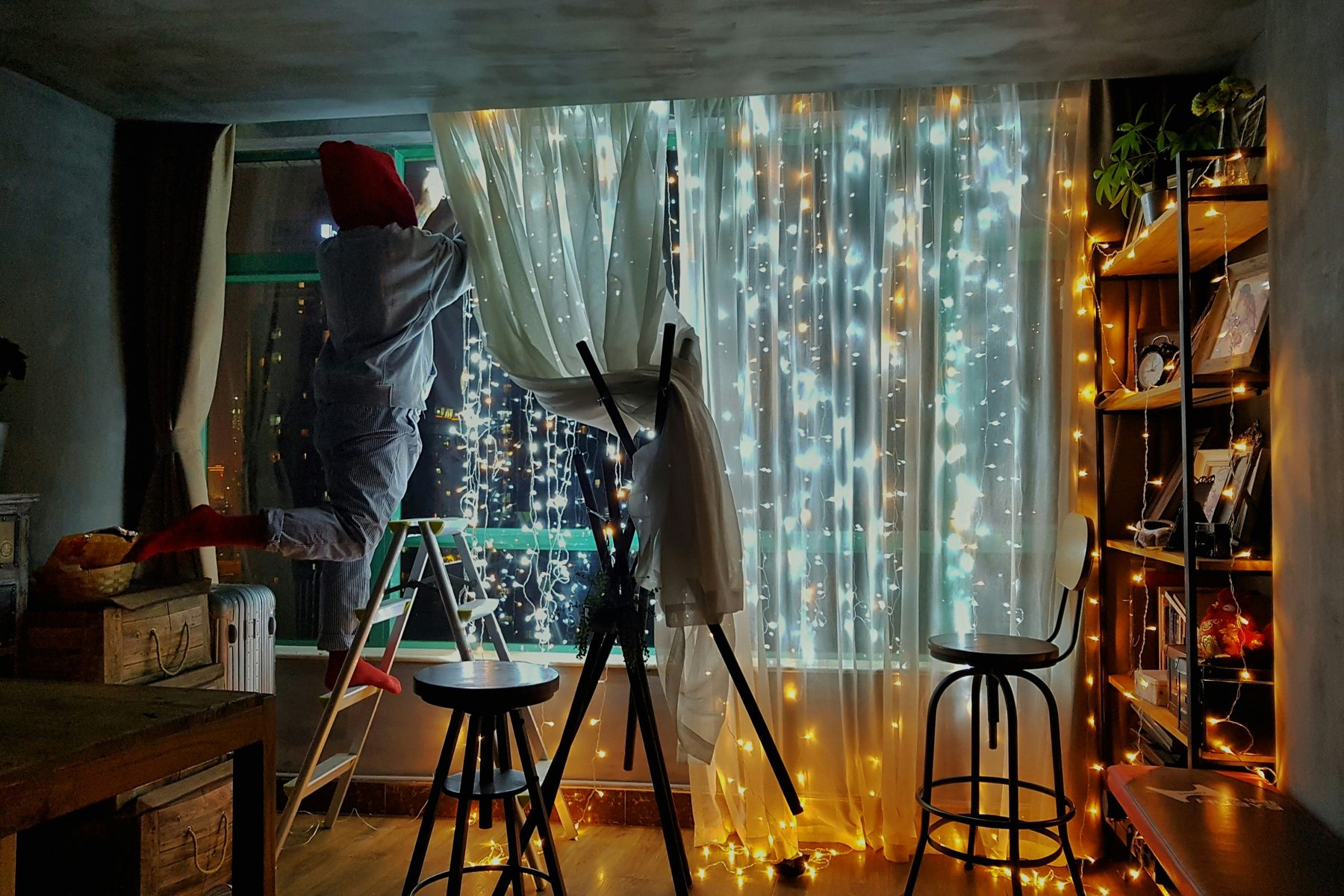 A bedroom full of stuff, fairy lights and half-finished projects